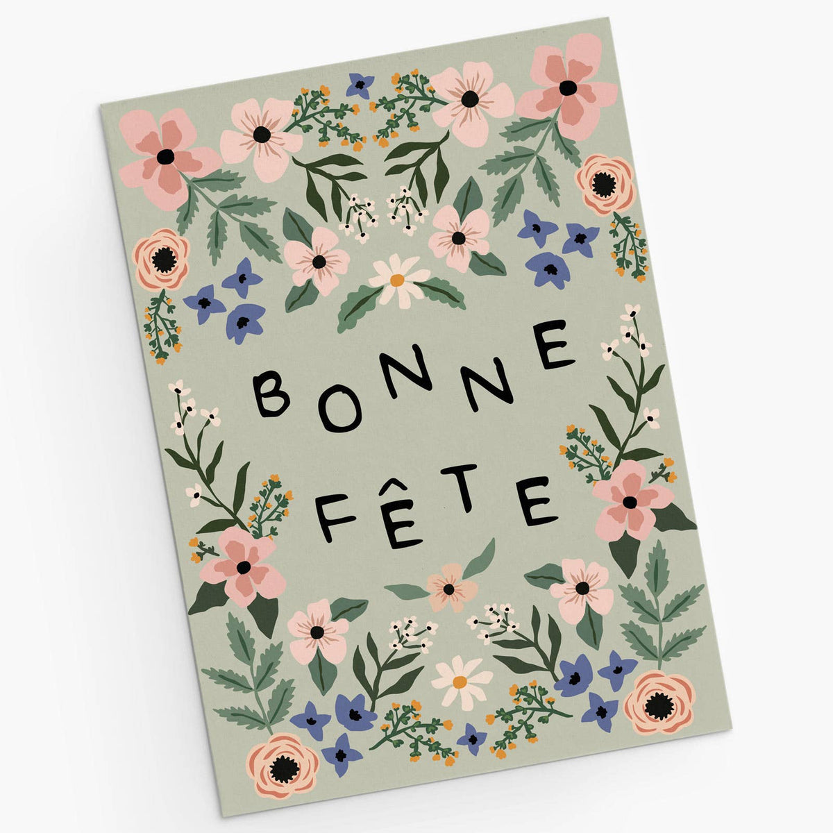 A rectangular greeting card with a sage green background, decorated with a border of pink, blue, and white flowers and green leaves. The words 'BONNE FÉTE' are printed in black capital letters in the center.