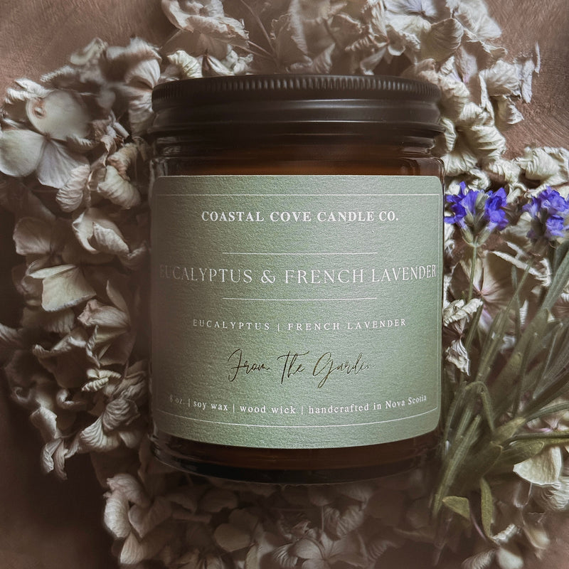 Coastal Cove Candle Co. candle with eucalyptus and French lavender scent on a floral background